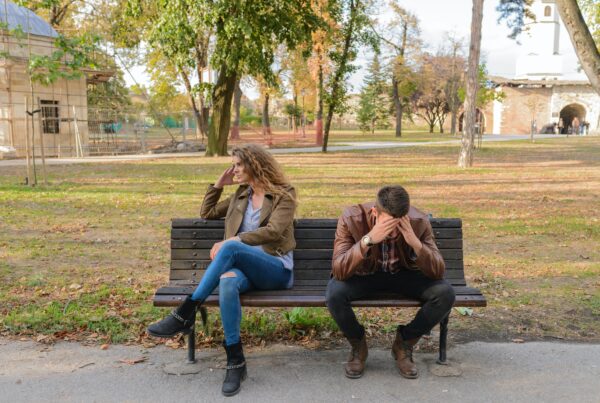A couple on a park bench after an argument