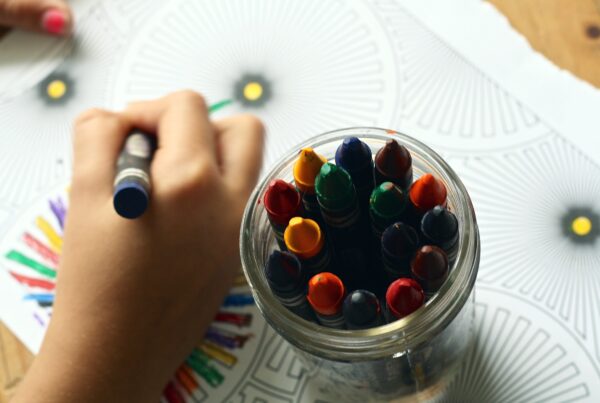 A child colouring with crayons